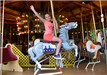 Young girl on a Merry-go-round horse