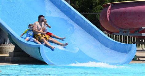 Dad with boys on slide