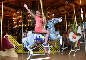Young girl on a Merry-go-round horse