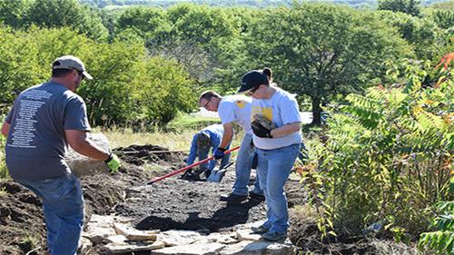 Westar volunteers add rock to trail